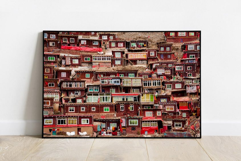 Print of a group of tiny red huts in Larung Gar settlement, China